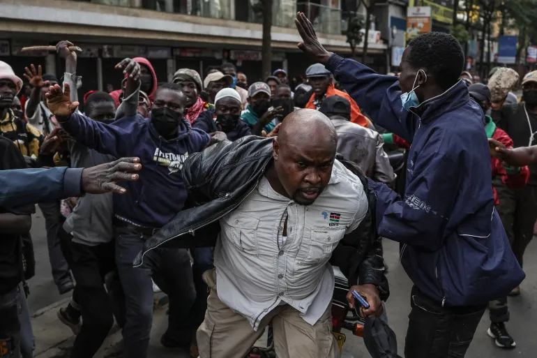 A man suspected of being a plain-clothed member of the Kenyan security forces is attacked by demonstrators marching in downtown Nairobi on June 25, 2025, during a planned day of protest [Tony Karumba/AFP]