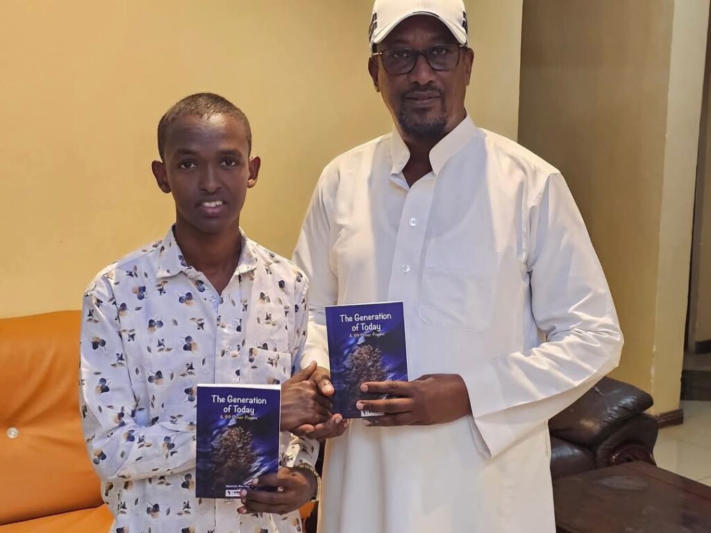 Dr. Mohamed Dahir and a young author holding copies of "The Generation of Today